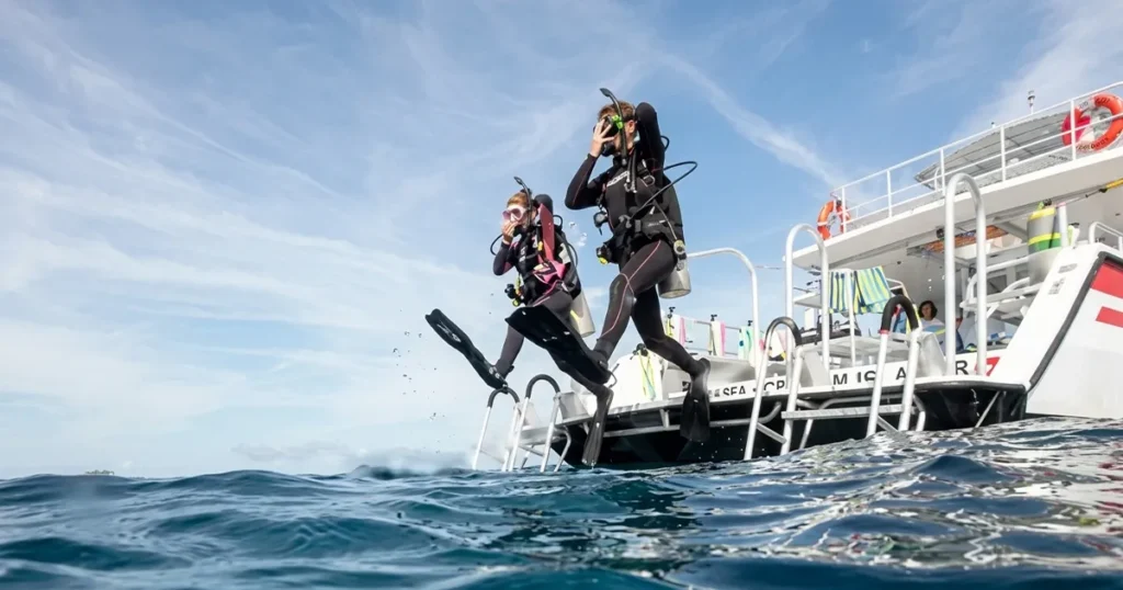 Divers entering the water from the boat | Discover Scuba Diving in Dibba Al Fujairah Nemo Diving Center