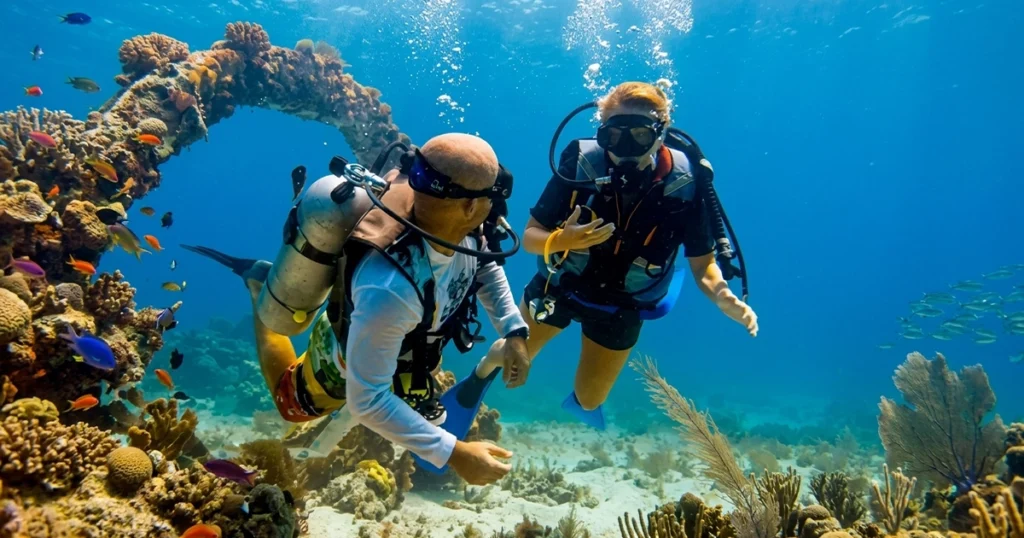 Instructor guiding a first-time diver over the reef | Discover Scuba Diving in Dubai Nemo Diving Center