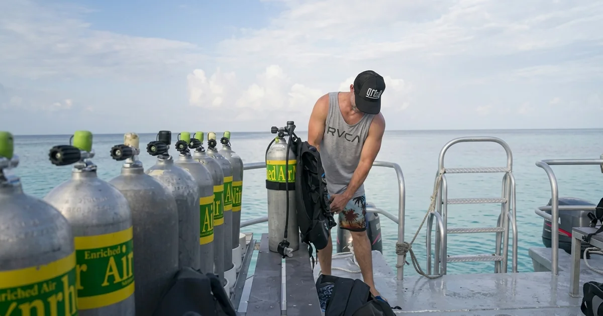 Man on a bout preparing for his PADI Enriched Air Nitrox Course Dubai