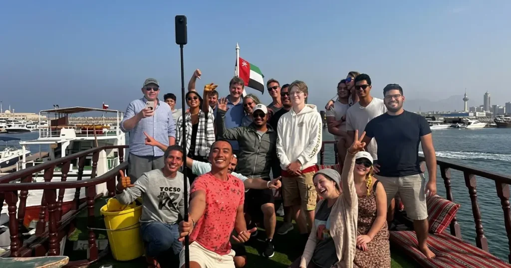 Group photo on the dhow deck with the UAE flag | Overnight Diving Trip in Musandam Nemo Diving Center
