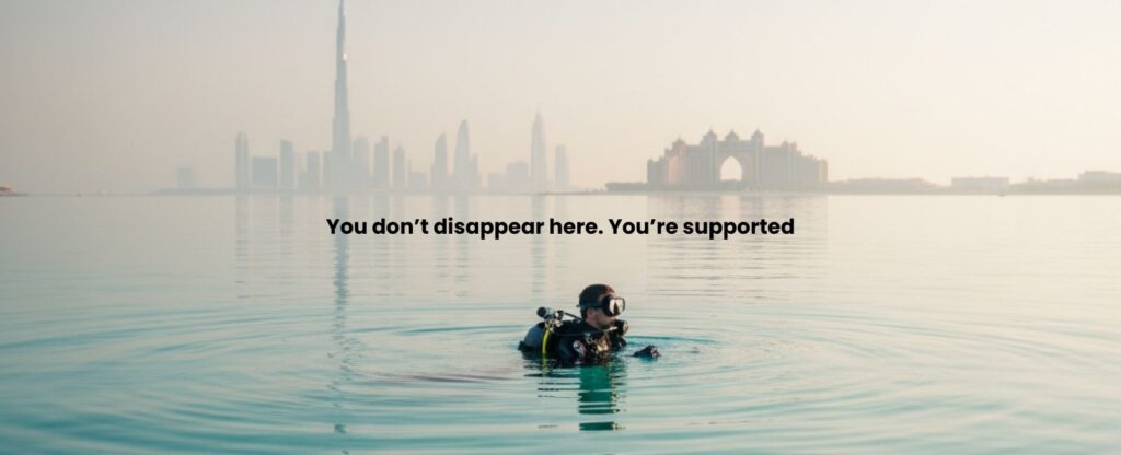 Best scuba diving experience in Dubai showing a calm diver floating at the surface with the Dubai skyline in the background.
